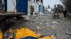 A body is covered by a tarp following a Russian bombing of a factory in Kramatorsk in eastern Ukraine, on April 19, 2022. 