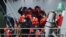 FILE - Migrants prepare to disembark from a UK Border Force boat at the port of Dover, having been picked up crossing the English Channel from France on April 15, 2022, at Dover, England.