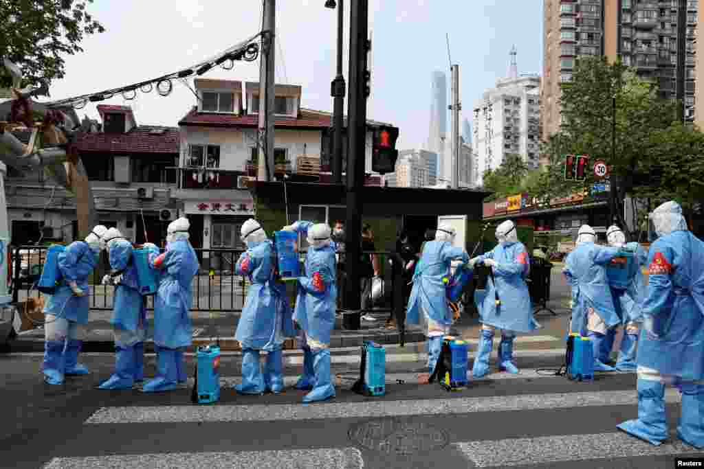 Workers in protective clothing prepare to disinfect a residential living area in Huangpu district, following the COVID-19 outbreak in Shanghai, China.(China Daily via REUTERS)