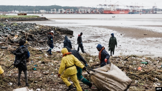 FILE: Volunteers clean up massive debris at the Durban harbor following heavy rains, mudslides and winds in Durban, South Africa, Apr. 16, 2022.