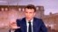 FILE - French President Emmanuel Macron gestures during a news broadcast of French TV channel TF1, outside Paris, April 13, 2022. 