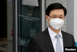 Former Hong Kong Chief Secretary for Administration and Chief Executive election candidate John Lee, leaves at the electoral affairs office after submitted his candidacy, in Hong Kong, April 13, 2022.