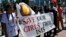 FILE - Women hold a banner during a demonstration marking the first anniversary of Islamic State's surge on Yazidis of the town of Sinjar, in front of the United Nations European headquarters in Geneva, Switzerland, August 3, 2015.