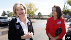 Sen. Cindy Hyde-Smith, R-Miss., left, campaigns at Mama Hamil's Restaurant in Madison, Mississippi, Nov. 6, 2018.