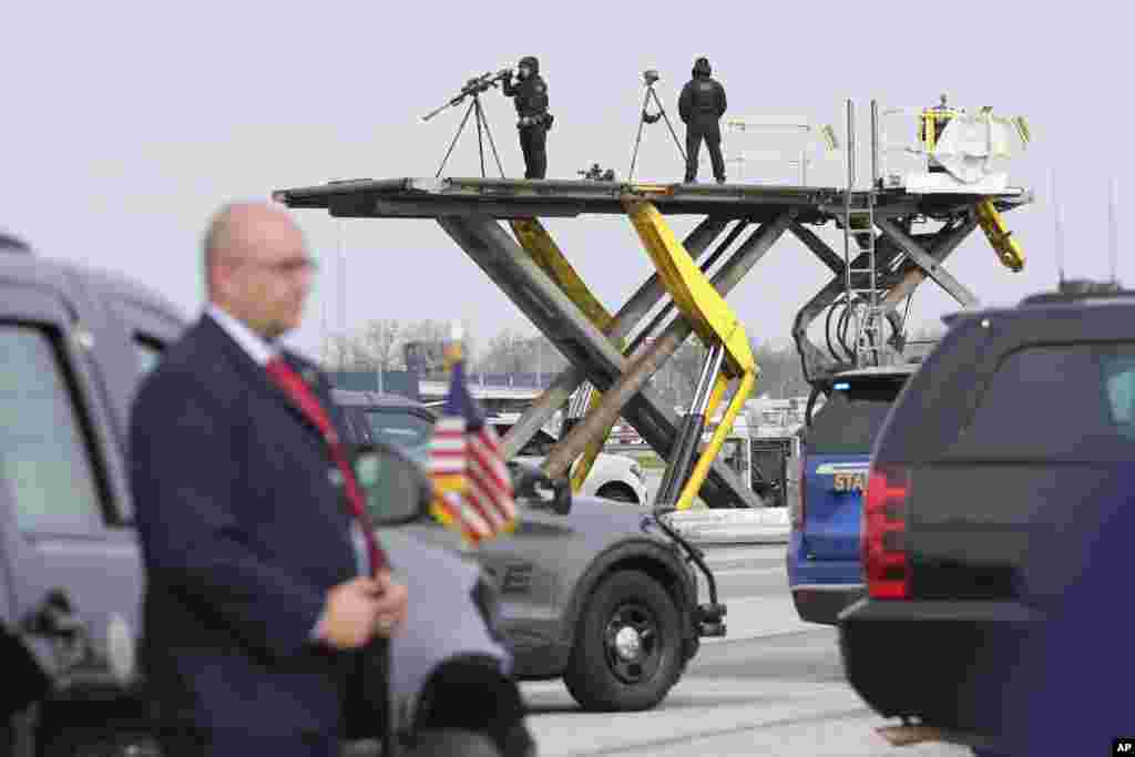 Secret Service counter-snipers monitor as Democratic presidential nominee Vice President Kamala Harris arrives to board Air Force Two at Detroit Metropolitan Wayne County Airport in Detroit, Michigan, en route to Pennsylvania.