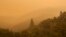 Smoke from a wildfire spreads over woods, as seen from White Rock in Carmel Valley, southeast of Monterey, Calif., July 27, 2016.