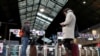 Travelers wait for a train at the Saint-Lazare railway station during a strike by all unions of French SNCF workers and the Paris transport network (RATP) as trade unions press on with a transport strike over the festive holidays in Paris, France,…