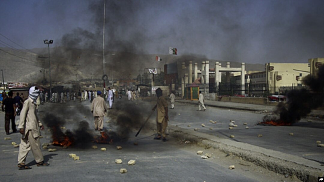 Angry Shiite Muslims burn tires as a protest against the killing of their community members by unidentified gunmen in Quetta, Pakistan, July 30, 2011