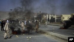 Angry Shiite Muslims burn tires as a protest against the killing of their community members by unidentified gunmen in Quetta, Pakistan, July 30, 2011