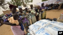 Women wait to receive baby food in Koleram, southern Niger, during the launch of a UN-backed feeding operation aimed at fighting malnutrition among young children.