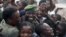 People greet a government an army FARDC soldier as he returns to Goma, December 3, 2012. 