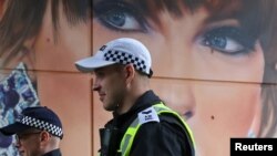 Agentes de policía pasan junto a un mural de Taylor Swift pintado junto al estadio de Wembley mientras estaban de servicio para el partido de fútbol Community Shield, en Wembley, Londres, Gran Bretaña, el 10 de agosto de 2024.