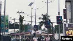 Hooded armed men in military fatigues stand on a street after unidentified gunmen attacked military barracks and attempted to break into an armoury at Congo Cross roundabout in Freetown, Sierra Leone November 26, 2023.