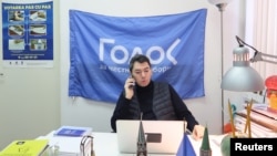 Co-chairman of Golos non-governmental organization Grigory Melkonyants speaks on the phone at his office in Moscow, Russia March 13, 2018. 