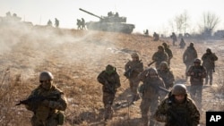 Ukrainian servicemen of the 3rd Separate Tank Iron Brigade take part in a drill, not far from the frontlines, in the Kharkiv area, Ukraine, Thursday, Feb. 23, 2023. 