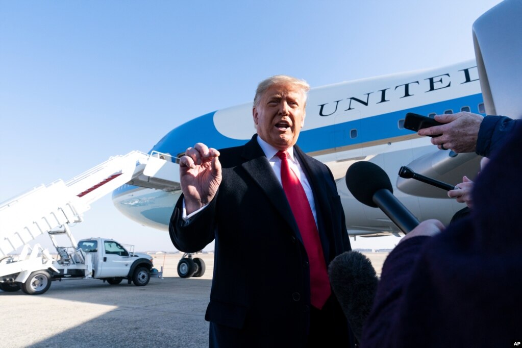 President Donald Trump speaks with reporters before boarding Air Force One Jan. 12, 2021, at Andrews Air Force Base, Maryland, to travel to Texas.