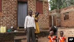 FILE— Barbara Nabulo who lives with sickle cell disease jokes with her husband at Busamaga-Mutukula village in Mbale, Uganda, April 25, 2024.