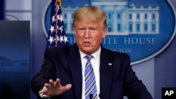 FILE - President Donald Trump speaks about the coronavirus in the James Brady Briefing Room, March 23, 2020, at the White House, in Washington.