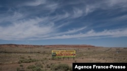 A sign promoting social distancing sits near the Navajo Nation town of Chinle, May 22,2020.