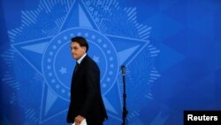 Brazil's President Jair Bolsonaro walks after a meeting with the governors to define strategies to combat to COVID-19 during the coronavirus disease (COVID-19) outbreak in Brasilia, Brazil, March 23, 2020.