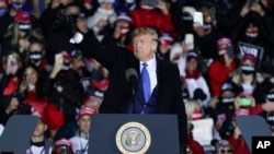 President Donald Trump waves after speaking at a campaign rally at the Waukesha County Airport on Oct. 24, 2020, in Waukesha, Wisconsin. 