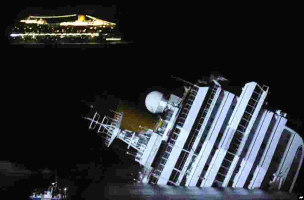 The cruise ship Costa Serena sails as its sister ship Costa Concordia cruise ship lays on its side after it ran aground off the west coast of Italy at Giglio island January 18, 2012.