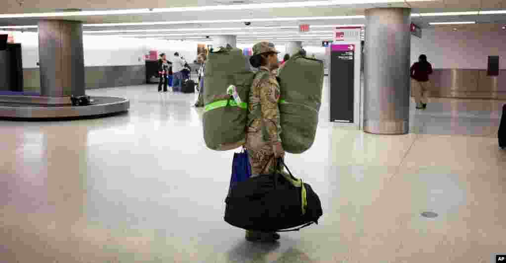 U.S. Army Sgt. Angelica Ciriaco makes her way home at the Miami International Airport, Nov. 26, 2013, after serving for 10 months in Afghanistan. 