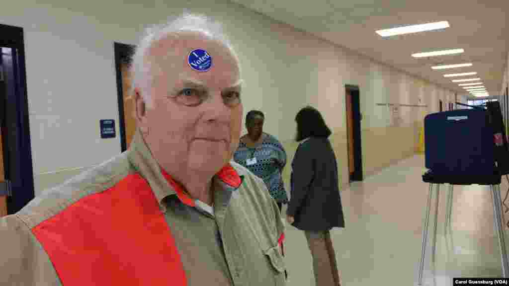 Hal Marshall playfully displays his commitment to voting after casting a ballot at Charleston's Burke High School in South Carolina's Republican primary, Feb. 20, 2016. Marshall says he voted for "the big guy," Donald Trump. 