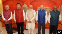 FILE - Leaders of BRICS countries, from left, Brazilian President Michel Temer, Chinese President Xi Jinping, Indian Prime Minister Narendra Modi, Russian President Vladimir Putin and South African President Jacob Zuma pose for a group photograph before a dinner hosted by Modi in Goa, India, Oct. 15, 2016.