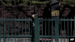 FILE - A Chinese paramilitary policeman stands guard outside the North Korean Embassy in Beijing, Feb. 7, 2016.