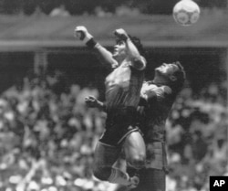 FILE - In this June 22, 1986 file photo Argentina's Diego Maradona, left, beats England goalkeeper Peter Shilton to a high ball and scores his first of two goals in a World Cup quarterfinal soccer match against England, in Mexico City.