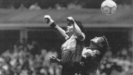 FILE - In this June 22, 1986 file photo Argentina's Diego Maradona, left, beats England goalkeeper Peter Shilton to a high ball and scores his first of two goals in a World Cup quarterfinal soccer match against England, in Mexico City.