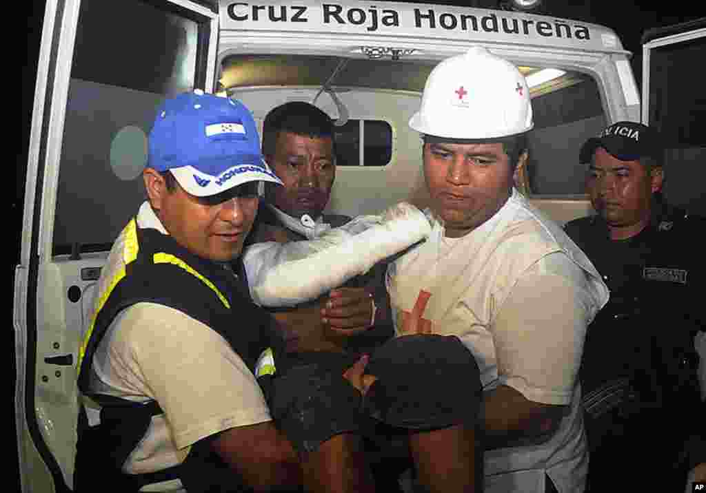 An injured inmate is carried as he arrives at the hospital after a fire broke out at the prison in Comayagua, Honduras, killing hundreds, February 15, 2012. (AP)