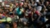 Mourners stampede after the arrival of the coffin carrying former President Robert Mugabe at the Rufaro Stadium in Harare, Thursday, Sept. 12, 2019 where Mugabe will lie in state for a public viewing. 