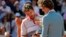 Former Brazilian tennis player Gustavo Kuerten (R) gives the trophy to Stan Wawrinka of Switzerland during the ceremony after he won the men's singles final match against Novak Djokovic of Serbia at the French Open tennis tournament, June 7, 2015. 