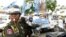A Cambodian military police officer, left, traffics during the election campaign in Phnom Penh, file photo.