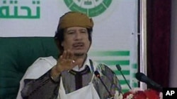 This video image taken from Libyan state television broadcast Wednesday March 2, 2011 shows Libyan leader Moammar Gadhafi addressing supporters and foreign media on Wednesday in a conference hall in the capital Tripoli, Libya