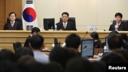 FILE - Judges sit to preside over a trial of crew members of the sunken ferry Sewol at Gwangju District Court in Gwangju, June 10, 2014.
