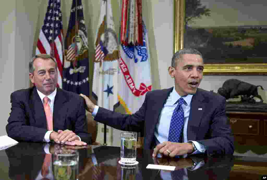 President Barack Obama acknowledges House Speaker John Boehner of Ohio while speaking to reporters in the Roosevelt Room of the White House in Washington, Friday, Nov. 16, 2012, as he hosted a meeting of the bipartisan, bicameral leadership of Congress to discuss the deficit and economy. (AP Photo/Carolyn Kaster)