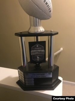 Fantasy football players like Nima Vaez-Zadeh often vie for the right to win their league's trophy for a year.