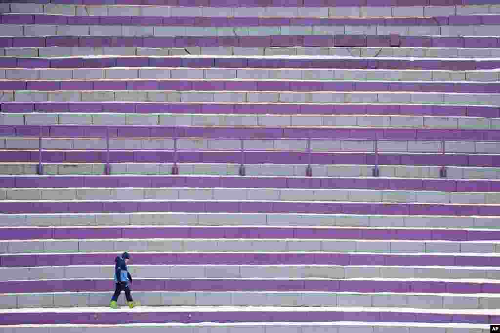 A lone spectator stands during competition jumps at the the third stage of the 69th Four Hills ski jumping tournament in Innsbruck, Austria.