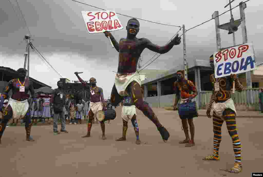 Actors parade on a street after performing at Anono school, during an awareness campaign against Ebola, in Abidjan, Sept. 25, 2014. 