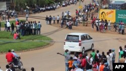 People gather on May 12, 2015 in Beni, in the North-Kivu eastern province, after five people were killed in a new attack blamed on Ugandan rebels near the town. 