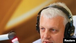 FILE - Journalist Pavel Sheremet talks on the air at a radio station in Kyiv, Ukraine, Oct. 11, 2015. 