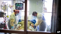 Dr. William Dittrich tampak mengamati pasien yang terinfeksi COVID-19 di ruangan Medical Intensive Care Unit (MICU) di Rumah Sakit St. Luke' Boise di Idaho, AS, pada 31 Agustus 2021. (Foto: AP/Kyle Green)