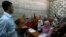 FILE - A Syrian teacher (L) is seen teaching at a school built for Syrian refugees in the southern port city of Sidon, Lebanon.