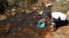 Residences of Mabvuku fetch water from unproteacted sources in Harare, Zimbabwe, July 28, 2012.