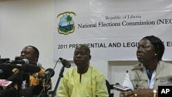 National Elections Commission Chairman James Fromayan (C) delivers the first results of Liberia's presidential election during a news conference in Monrovia, October 13, 2011.