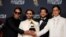 Los miembros de la banda venezolana Rawayana pasan con un premio Grammy tras ganar la categoría a mejor álbum latino de rock o música alternativa, en Los Ángeles, Estados Unidos, el 2 de febrero de 2025.
