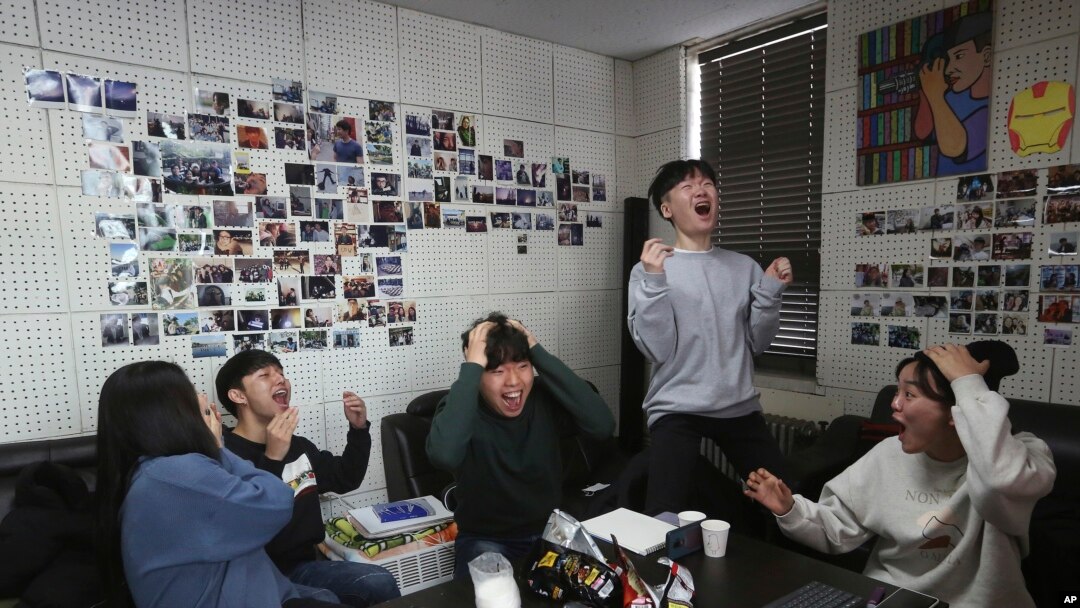Film club members celebrate as they watch a TV live broadcasting of South Korean director Bong Joon Ho's "Parasite" receiving the award for best picture at the Oscars, at the Yeonsei University in Seoul, South Korea, Feb. 10, 2020.